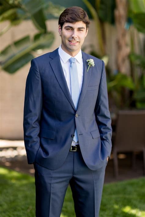 navy blue suit with light blue tie